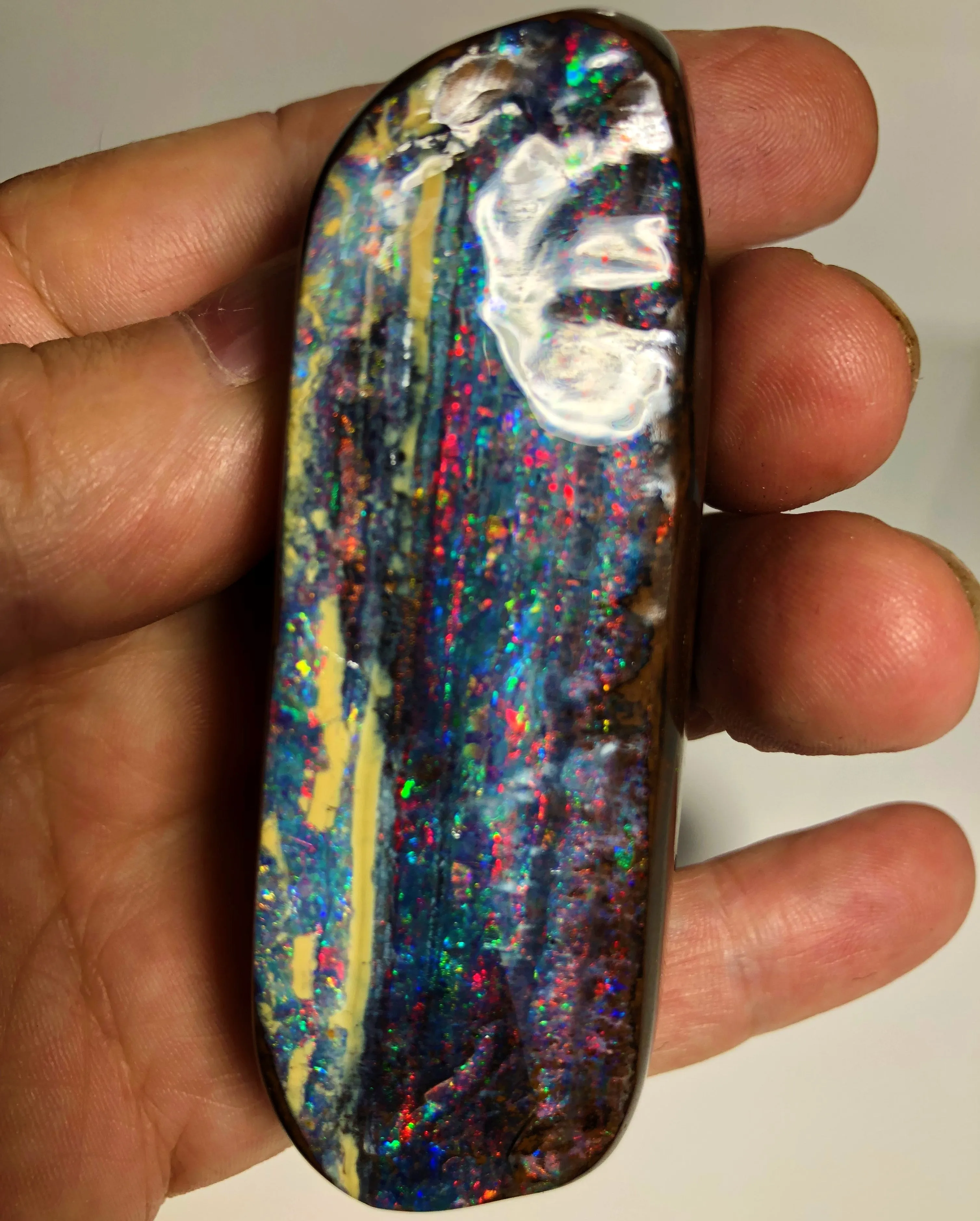 Red multi coloured boulder opal polished speciman